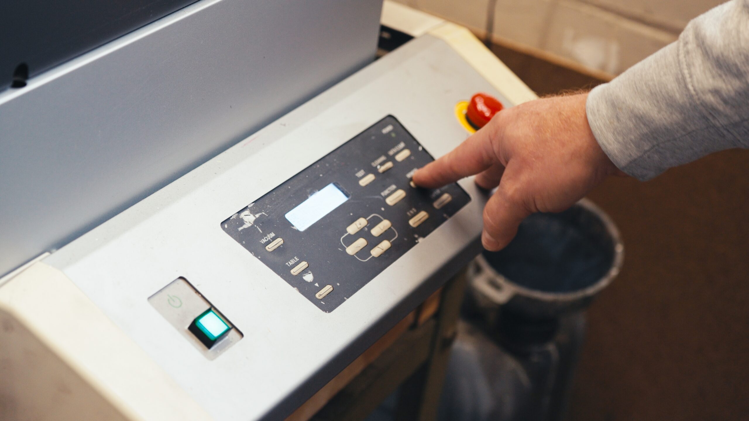 worker turning printer on